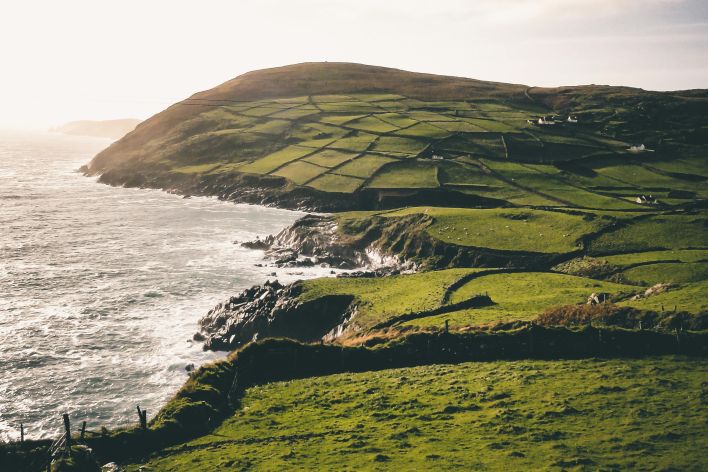 Breathtaking view of Ireland's green hills meeting the ocean, perfect for nature enthusiasts.
